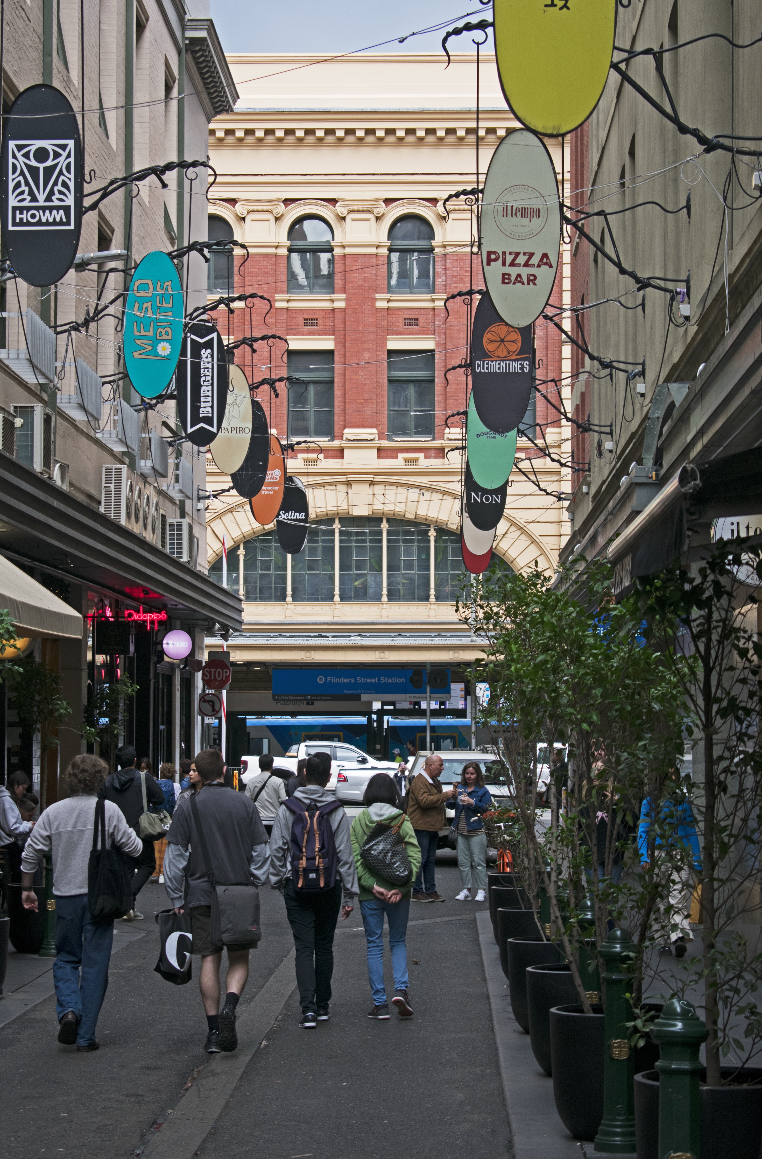 Degraves Street, Melbourne, with venue signs hanging over the laneway